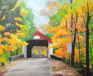 A Covered bridge, one with a roof, in Pennsylvania USA surrounded by fall foliage
